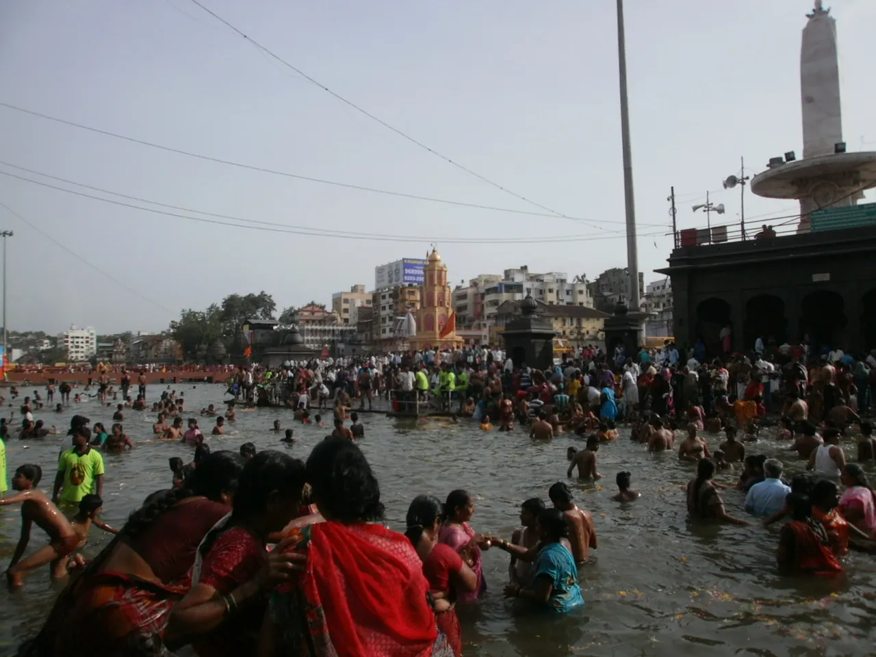 Devotees bathing in the Godavari river at Nashik