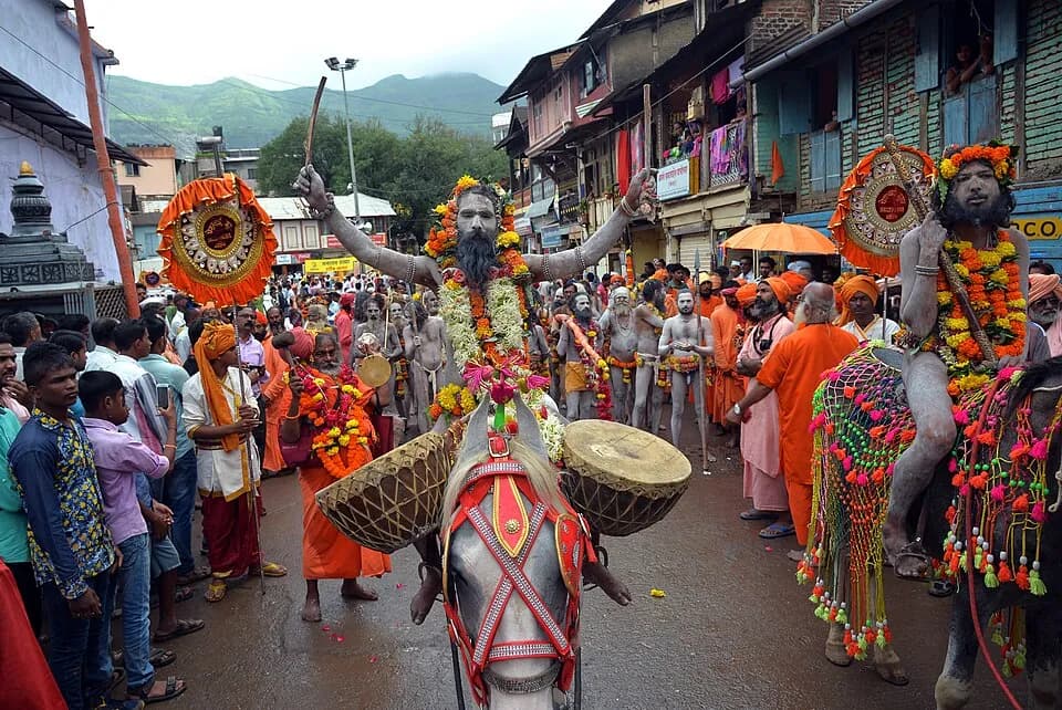 Garlanded sadhus in a procession through Trimbak streets during Simhastha